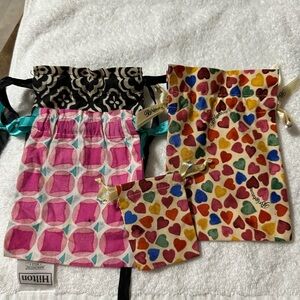 Bundle of 4 Brighton fabric jewelry bags with draw string closure.